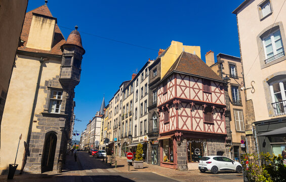 RIOM, FRANCE - AUGUST 12, 2022: Typical facades built with volcanic stones in the clock tower street of Riom, France