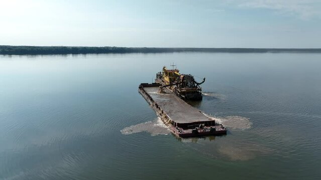 Aerial view. A dredger for extracting river sand and cleaning the river bottom in the middle of the Volga.