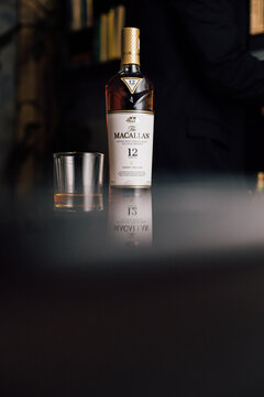 person with a bottle of whisky