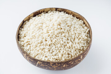 arborio rice for risotto on a white acrylic background