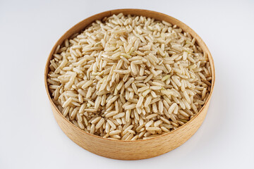 raw unpolished rice on a white acrylic background