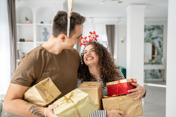 man and woman give gift box presents at home holiday surprise concept