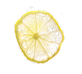 Juicy lime slices with bubbles under water isolated on white background. Yellow lemon slices...