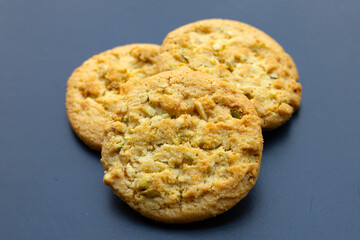 Pistachio and almond cookies on dark background.