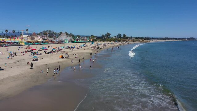Tourists Enjoying Summer Day on Northern California Coast at Santa Cruz Beach