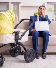 Young businessman looking after baby