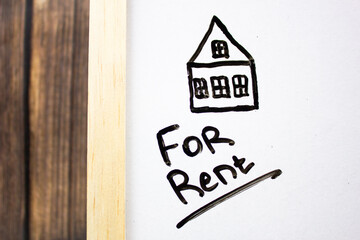 FOR RENT - text concept with drawn house on white board. Business concept of renting or renting housing, houses, real estate.
