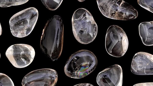 Smoky quartz rare jewel stones texture on black background. Moving right seamless loop backdrop.