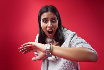 Young woman shocked at the time on his wrist watch, she's late for a meeting - 544496892