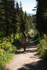 Fototapeta premium Woman hiking in the woods near Lake Louise, Alberta, Canada.