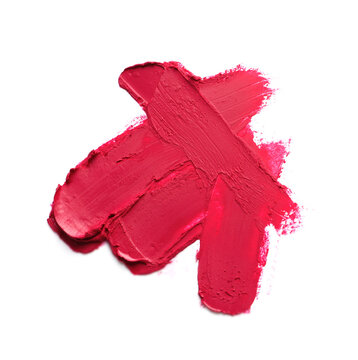 Smears of bright lipstick on white background, top view