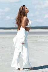 Fototapeta na wymiar Beautiful woman standing on seashore