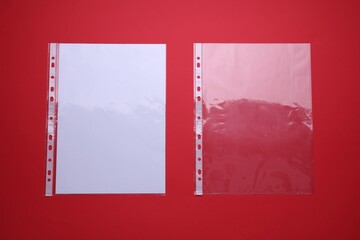 Punched pockets on red background, flat lay