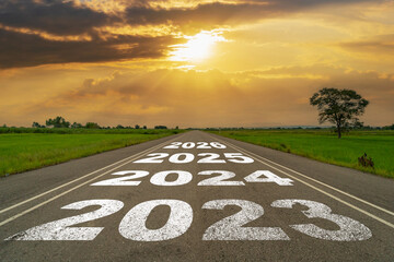 Empty asphalt road and New year 2023 concept. Driving on an empty road to 2023 with sunset. - 544502819
