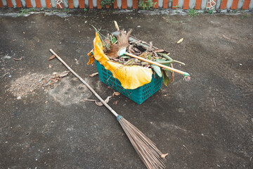 rash and broom on cement floor