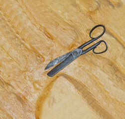Old tailor scissors isolated on golden background with shadow