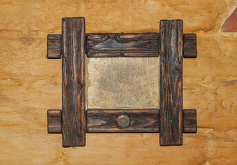 Antique wooden frame for pictures, mirrors or photos on a golden background. Design element, advertising.