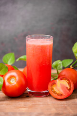 Fresh tomato juice on wooden table