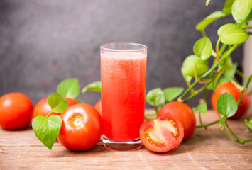 Fresh tomato juice on wooden table
