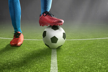 Football player man in a blue jersey standing with the ball