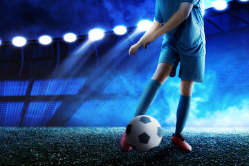 Football player man in a blue jersey kicking the ball
