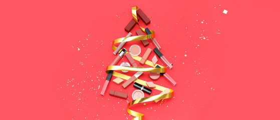 Christmas tree made of makeup cosmetics and ribbon on red background