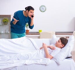 Young father caring for sick son