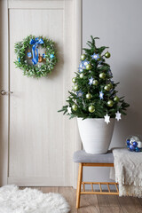 Fir tree with decor for Hanukkah on bench in hall