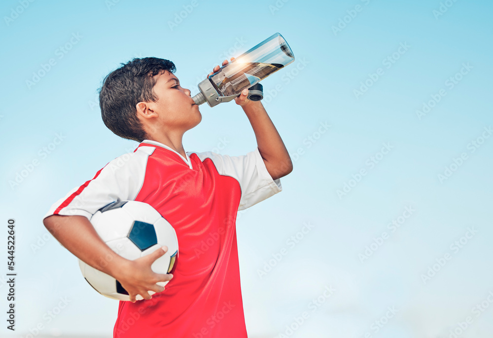 Wall mural Training, sports and football with child drinking water for fitness, health or endurance exercise. Wellness, summer and workout with young soccer player and bottle for electrolytes, relax and thirsty