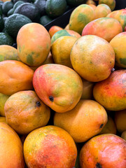 Tasty ripe mangoes as background, closeup