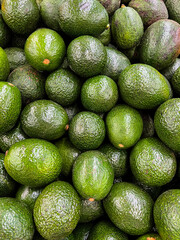 Tasty avocados as background, closeup
