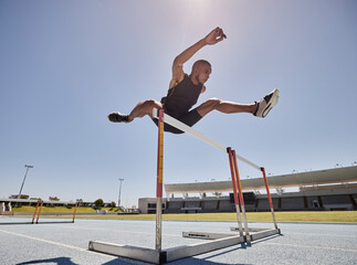 Running, jump and athlete hurdle for a speed exercise, marathon or runner training in a stadium....