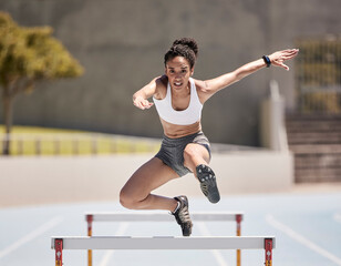 Jump, athlete and hurdle black woman in sports race, competition or training at stadium with...