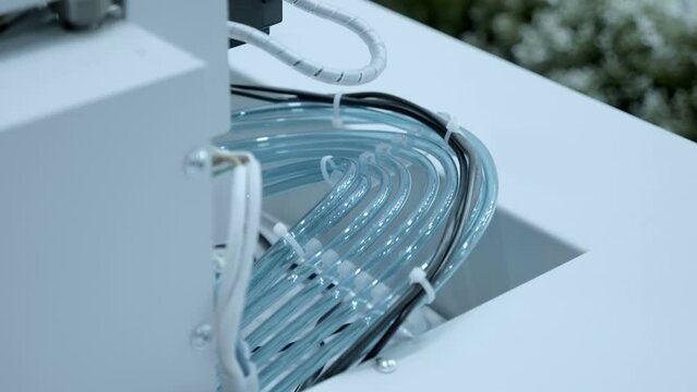 Group of transparent silicone (plastic) hoses (tubes) in industrial equipment for liquids or vacuum. Shot in motion. Closeup