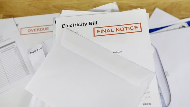 Close up of a stack of bills and letters with an electricity bill final notice