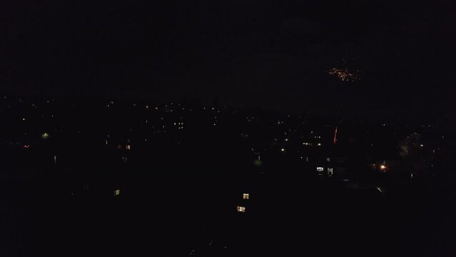 Drone, English November the 5th Bonfire night in the United Kingdom. Dark cold and wet, showing street lights houses and fireworks. Drone footage