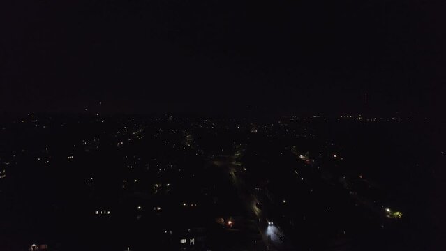 Beautiful colourful fireworks in the night sky shot by drone showing the town below