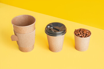 Paper cups with tea bag and coffee beans on color background