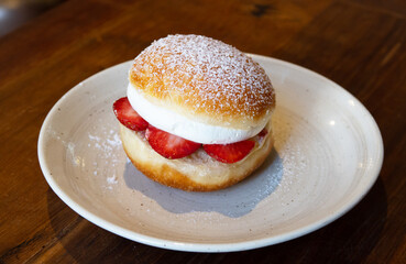 Strawberry and cream donut in japan style on white dish, sweet time dessert