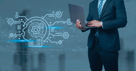 Businessman in black suit holding laptop and virtual screen on blue background, e-learning education Internet Technology Webinar Online Courses concept.