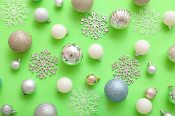 Christmas balls and snowflakes on green background
