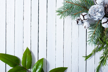 Christmas decoration evergreen cones and twigs on white wooden table background