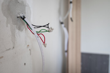 Red green black electrical wires hanging out of wall for new powerpoint home house renovations DIY...