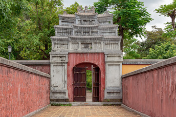 Colorful pink red stone gate design traditional architecture of the Hue Historic Citadel complex in Hue Vietnam