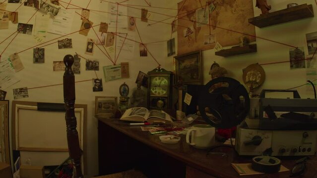 Tracking Shot Right to Left of a Conspiracy Theorists Workspace With Artifacts