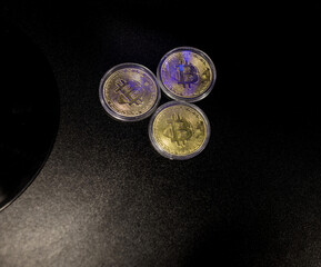 Three Gold Bitcoin Cryptocurrency Coins.
