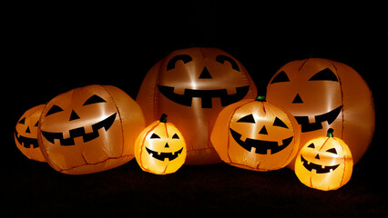 Inflatable pumpkins glowing in the dark for Halloween decorations.