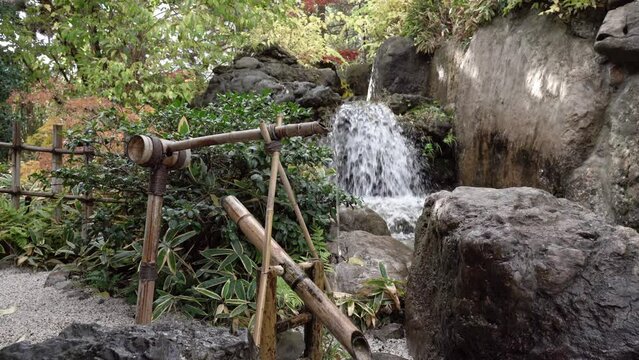 Shishi-odoshi (sōzu) in the Japan Garden.  Japanese devices made to frighten away animals. Water fountain used in Japanese gardens are now a part of the visual and aural design of gardens