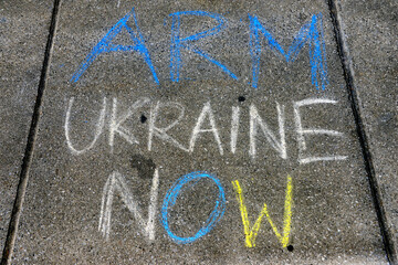 Grafitti written with chalk on pavement in front of Palace of Nations, May 2022, Geneva,...