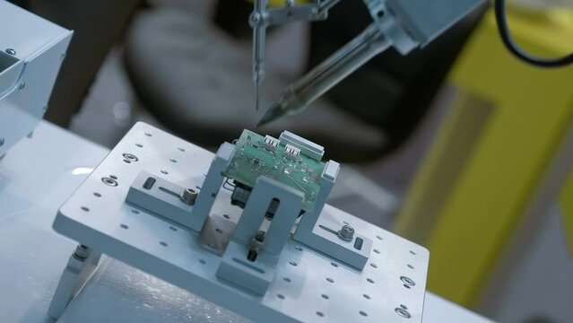 Industrial equipment for soldering according to the program of parts on the printed circuit board. Closeup
